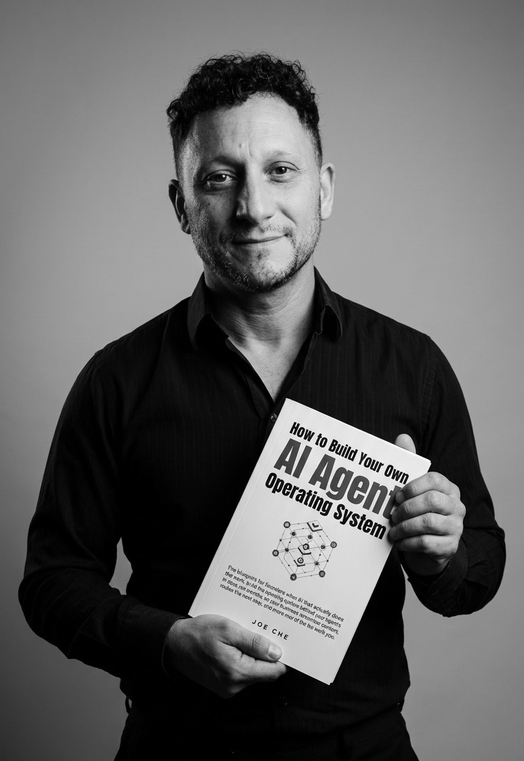 Joe Che holding How to Build Your Own AI Agent Operating System